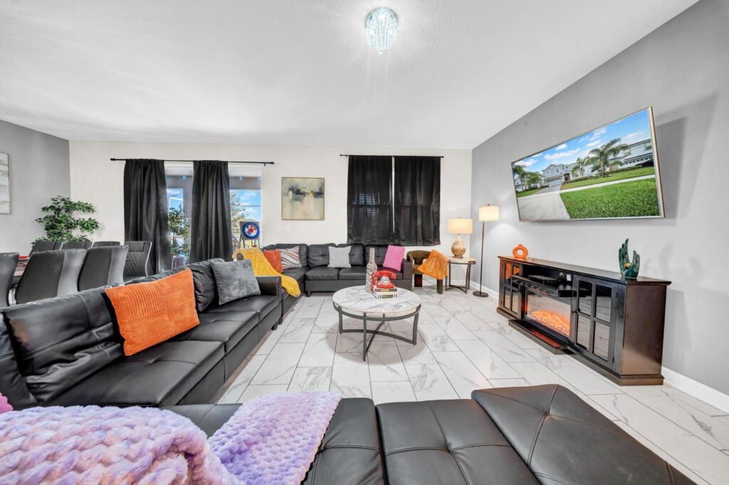 Bright living room in Orlando vacation rental home with natural light and cozy seating.